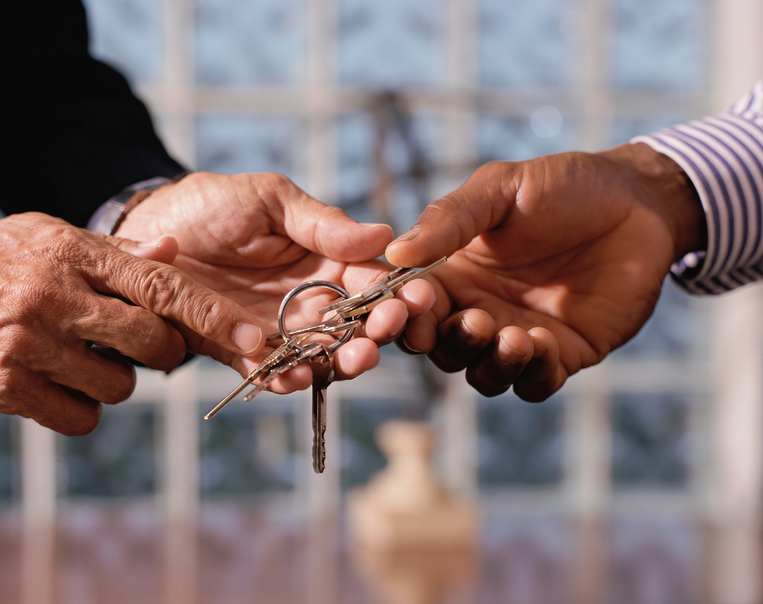 Men's hands exchanging keys